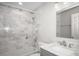 Bathroom with white marble tiled bathtub, shower, sink, and mirror at 13613 Laraway Dr, Riverview, FL 33579