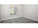 Bedroom featuring gray carpet, baseboards, a window, and painted walls at 13613 Laraway Dr, Riverview, FL 33579
