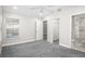 Spacious bedroom featuring gray carpet, a ceiling fan, and an ensuite bathroom with marble shower at 13613 Laraway Dr, Riverview, FL 33579