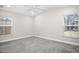 Neutral bedroom featuring carpet, vaulted ceiling, and two windows at 13613 Laraway Dr, Riverview, FL 33579