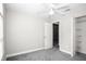 Bedroom with gray walls and carpet, a ceiling fan, and a walk in closet at 13613 Laraway Dr, Riverview, FL 33579