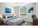 Bedroom with large window, gray walls, carpet, bed with pillows and throw blanket at 13613 Laraway Dr, Riverview, FL 33579