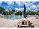 Community pool area with lounge chairs, picnic table, and clear blue water providing a refreshing recreational space at 13613 Laraway Dr, Riverview, FL 33579