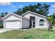 Well-maintained home with an attached two-car garage and mature landscaping at 13613 Laraway Dr, Riverview, FL 33579