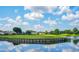 A scenic view of a lake surrounded by a golf course fairway and well-maintained landscaping at 13613 Laraway Dr, Riverview, FL 33579