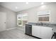 Bright kitchen area featuring large windows and stainless steel dishwasher at 13613 Laraway Dr, Riverview, FL 33579