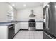 Bright kitchen features stainless steel appliances, tile flooring, and ample cabinet space at 13613 Laraway Dr, Riverview, FL 33579
