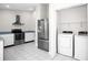 Well-equipped kitchen with stainless steel appliances and adjacent laundry area at 13613 Laraway Dr, Riverview, FL 33579