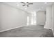 Neutral living room with carpet, ceiling fan and modern fixtures at 13613 Laraway Dr, Riverview, FL 33579