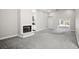 Spacious living room with a fireplace, sliding glass doors and neutral carpet at 13613 Laraway Dr, Riverview, FL 33579
