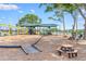Community playground with swings, climbing structures, and picnic tables creating a fun and engaging space for children at 13613 Laraway Dr, Riverview, FL 33579