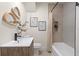 Updated bathroom features modern fixtures, gray tiled shower, and unique décor at 1443 Paloma Ln, Dunedin, FL 34698