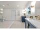 This bathroom features new dual sink vanities, modern gold fixtures, and neutral tile at 1443 Paloma Ln, Dunedin, FL 34698