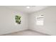 Bright bedroom with light hardwood floors and two windows at 1443 Paloma Ln, Dunedin, FL 34698