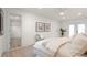 This bright bedroom features an ensuite bathroom, a ceiling fan, and access to the backyard at 1443 Paloma Ln, Dunedin, FL 34698