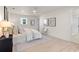 This bedroom features an ensuite bathroom, a ceiling fan and lots of natural light at 1443 Paloma Ln, Dunedin, FL 34698
