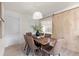 A cozy dining room showcases a rustic table with seating for six, complemented by a modern sliding barn door at 1443 Paloma Ln, Dunedin, FL 34698