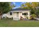 Charming single-story home with inviting front porch and landscaped front yard at 1443 Paloma Ln, Dunedin, FL 34698