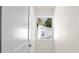 Narrow hallway with neutral walls and a view of the outside through a window at 1443 Paloma Ln, Dunedin, FL 34698