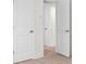 Hallway view with a white door open at 1443 Paloma Ln, Dunedin, FL 34698