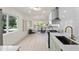 Modern kitchen with stainless steel appliances with an open floorplan and views of a serene lake at 1443 Paloma Ln, Dunedin, FL 34698