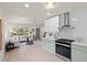 Kitchen and Living Room featuring stainless steel appliances and white subway tile back splash at 1443 Paloma Ln, Dunedin, FL 34698