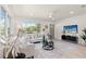 Beautiful living room with contemporary furnishings and large windows, offering serene views of the lake at 1443 Paloma Ln, Dunedin, FL 34698