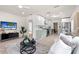 An open-concept living space showcases a contemporary interior with a seamless transition to the adjacent kitchen area at 1443 Paloma Ln, Dunedin, FL 34698