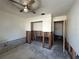 A bedroom in need of renovation has an exposed wall structure and fan overhead at 1503 12Th Se Ct # 1503, Largo, FL 33771