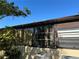 Exterior shot of the house showing a window, tree, and air conditioning units at 1503 12Th Se Ct # 1503, Largo, FL 33771