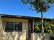Home exterior features a window, private patio, and mature tree shading the property at 1503 12Th Se Ct # 1503, Largo, FL 33771
