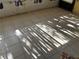 Tile floor with light streaming through the window in an empty room at 1503 12Th Se Ct # 1503, Largo, FL 33771