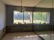 Sun-lit living room features a large window with a lush outdoor view and mirrored wall at 1503 12Th Se Ct # 1503, Largo, FL 33771