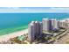 Coastal view showcasing high-rise condos, sandy beaches, and clear turquoise waters with resort-style amenities at 1560 Gulf Blvd # 306, Clearwater Beach, FL 33767