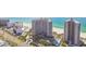 Stunning aerial view of beachfront condos with pools, tennis courts, and manicured grounds at 1560 Gulf Blvd # 306, Clearwater Beach, FL 33767