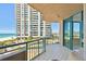 Spacious tiled balcony boasts ocean views, floor-to-ceiling windows, and comfortable seating at 1560 Gulf Blvd # 306, Clearwater Beach, FL 33767