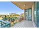 Large, tiled balcony offering beautiful views of the buildings and palm trees at 1560 Gulf Blvd # 306, Clearwater Beach, FL 33767