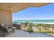 Condo balcony showing beach, palm trees, and ocean view with seating at 1560 Gulf Blvd # 306, Clearwater Beach, FL 33767