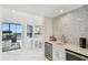 Stylish bar area with wine fridge, custom backsplash, and access to the living room at 1560 Gulf Blvd # 306, Clearwater Beach, FL 33767