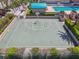 Aerial view of a green outdoor basketball court with a white hoop near a swimming pool and buildings at 1560 Gulf Blvd # 306, Clearwater Beach, FL 33767