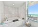 Beautiful bathroom with jetted tub by window overlooking the ocean at 1560 Gulf Blvd # 306, Clearwater Beach, FL 33767