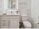 Modern bathroom featuring marble walls, a sleek vanity, and a toilet at 1560 Gulf Blvd # 306, Clearwater Beach, FL 33767