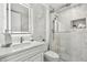 Modern bathroom featuring a marble vanity, lighted mirror, and glass shower at 1560 Gulf Blvd # 306, Clearwater Beach, FL 33767