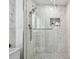 Bathroom features glass shower, white marble walls, and sleek fixtures at 1560 Gulf Blvd # 306, Clearwater Beach, FL 33767