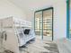 Cozy bedroom with a bunk bed, soft rug, and sliding glass doors leading to a balcony at 1560 Gulf Blvd # 306, Clearwater Beach, FL 33767