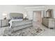 Inviting main bedroom featuring marble floors, tufted headboard and an ensuite bathroom at 1560 Gulf Blvd # 306, Clearwater Beach, FL 33767