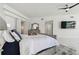 Spacious bedroom with coastal views, ceiling fan, and large flat-screen TV at 1560 Gulf Blvd # 306, Clearwater Beach, FL 33767