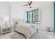 Serene bedroom featuring a queen bed, stylish ceiling fan, and large window with stunning views at 1560 Gulf Blvd # 306, Clearwater Beach, FL 33767