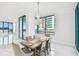 Elegant dining area with stylish furniture, chandelier, and large windows at 1560 Gulf Blvd # 306, Clearwater Beach, FL 33767