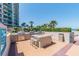 Outdoor grilling area equipped with multiple grills and a countertop island at 1560 Gulf Blvd # 306, Clearwater Beach, FL 33767